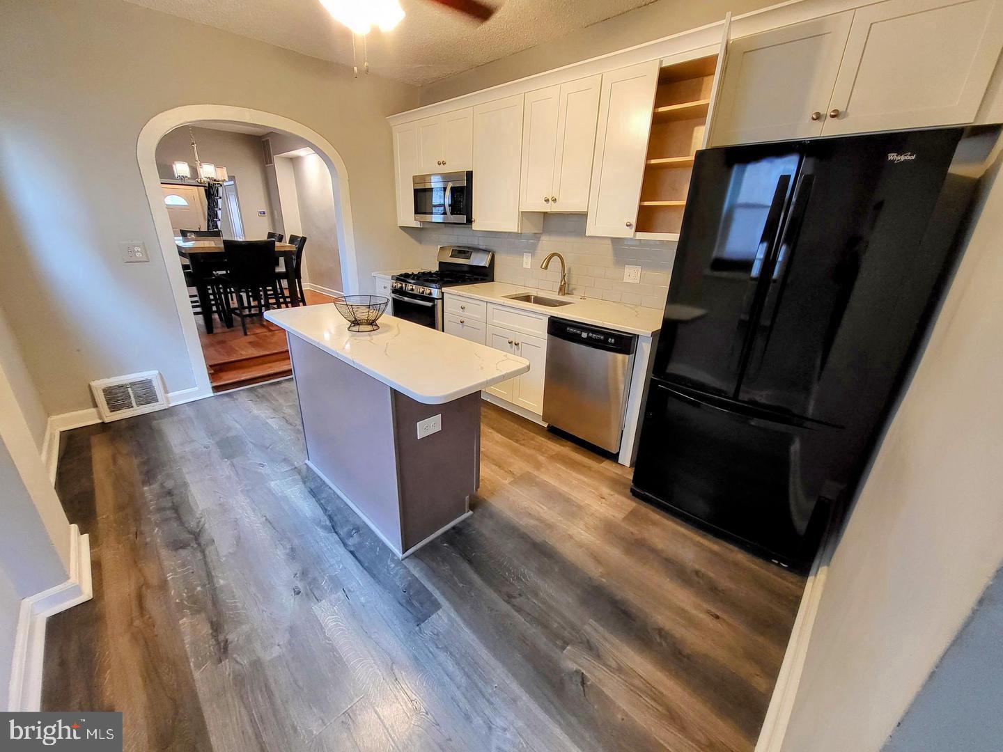 2237 Federal Street Philadelphia, PA 19146 - Photo 10 of 25 a kitchen with sink a refrigerator and wooden floor