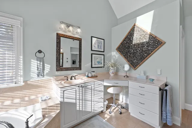 a backyard of a house with sofas table and chairs