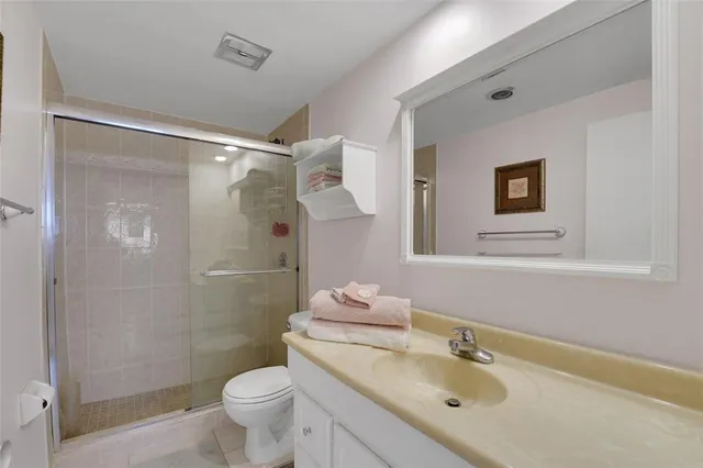 a bathroom with a sink mirror vanity and toilet