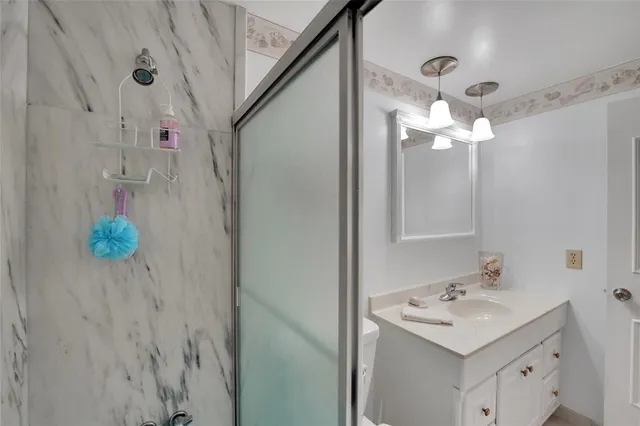a bathroom with a sink vanity and a mirror