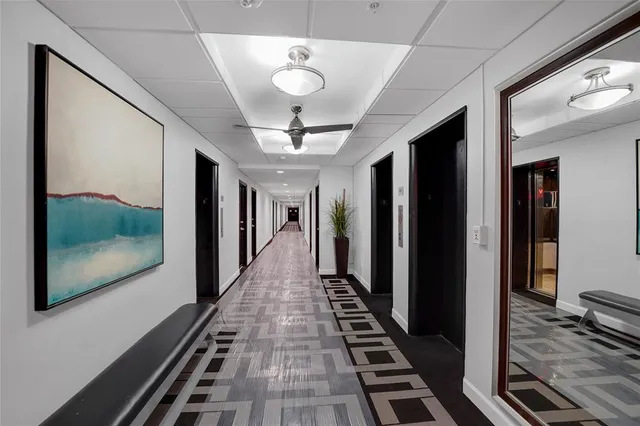 a view of a hallway with wooden floor and stairs