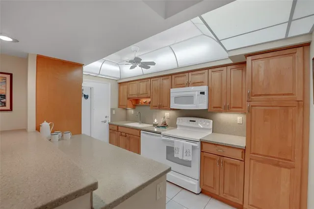 a kitchen with stainless steel appliances granite countertop cabinets and a refrigerator