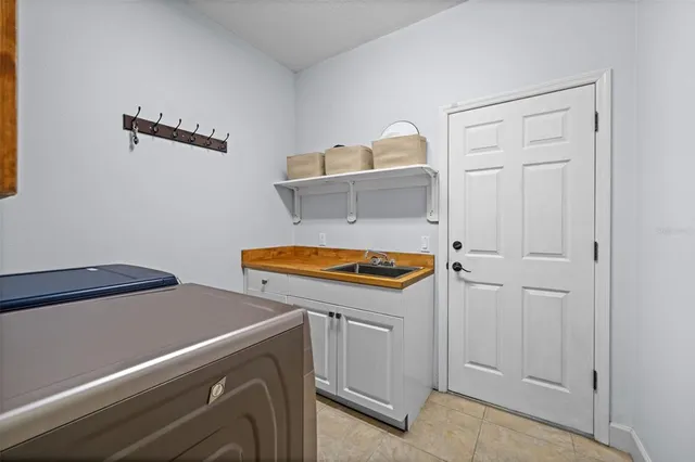 a spacious bathroom with a tub double sink window and mirror