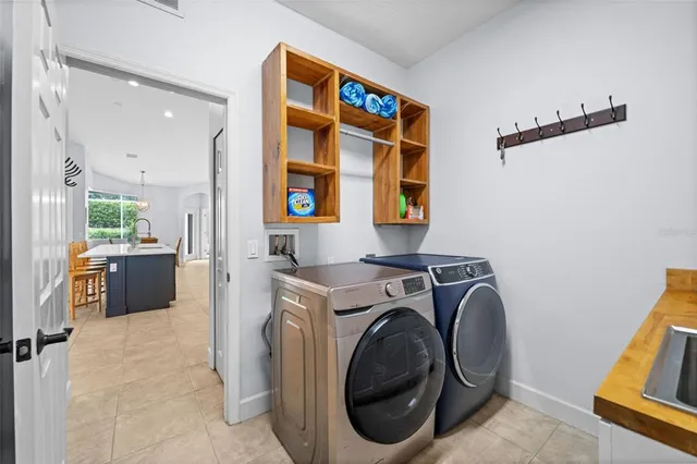 a spacious bathroom with a double vanity sink a large mirror and a bathtub
