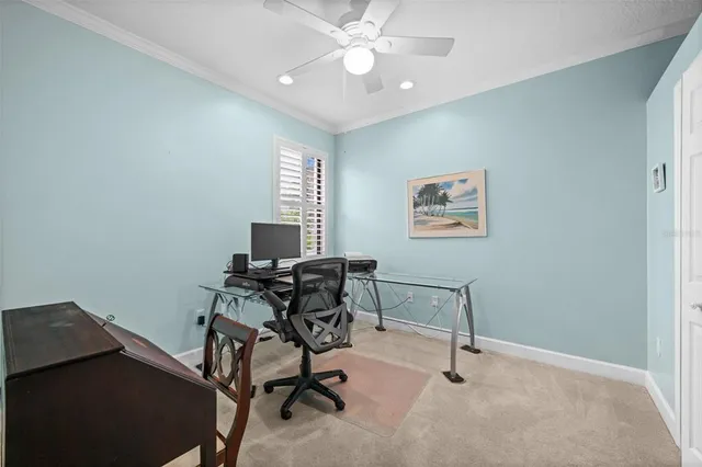 a view of a workspace with furniture and a window