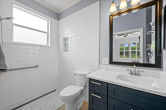 a large bathroom with a large tub sink and mirror