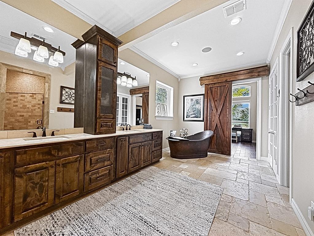 909 Higginbotham Lane China Spring, TX 76633 - Photo 13 of 40 a large spacious bathroom with a large mirror vanity and a sink