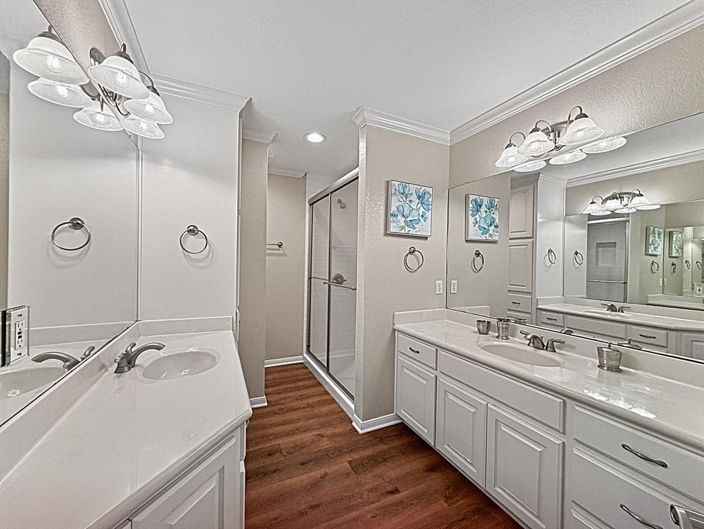909 Higginbotham Lane China Spring, TX 76633 - Photo 19 of 40 a spacious bathroom with a double vanity sink a large mirror and shower