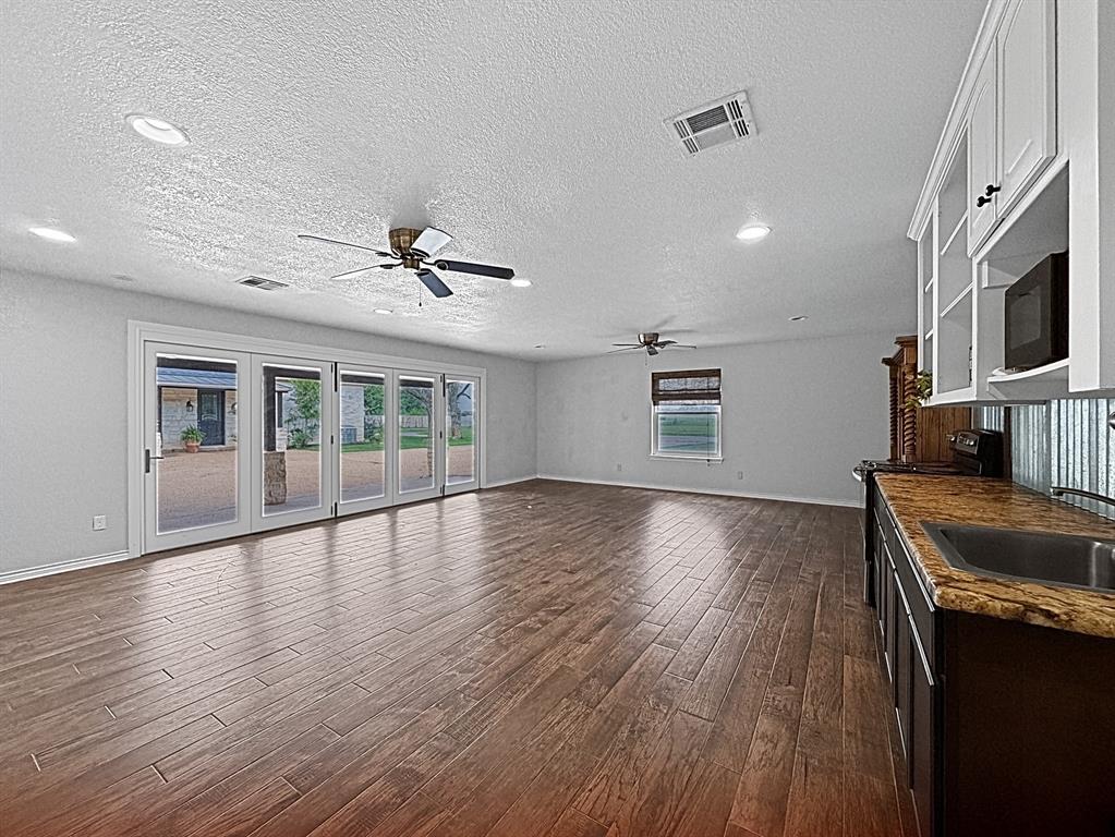 909 Higginbotham Lane China Spring, TX 76633 - Photo 21 of 40 a view of an empty room with a window and wooden floor