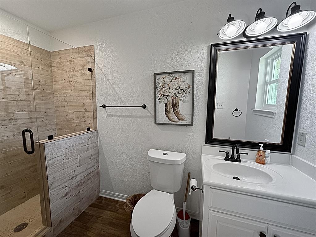909 Higginbotham Lane China Spring, TX 76633 - Photo 22 of 40 a bathroom with a toilet a sink and mirror