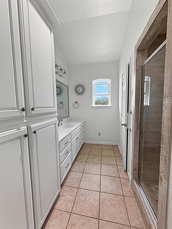 909 Higginbotham Lane China Spring, TX 76633 - Photo 25 of 40 a bathroom with a sink a mirror and a shower