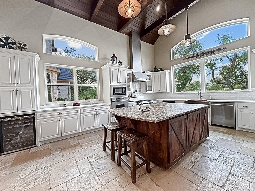 909 Higginbotham Lane China Spring, TX 76633 - Photo 4 of 40 a kitchen with stainless steel appliances granite countertop a sink a stove and a wooden floors