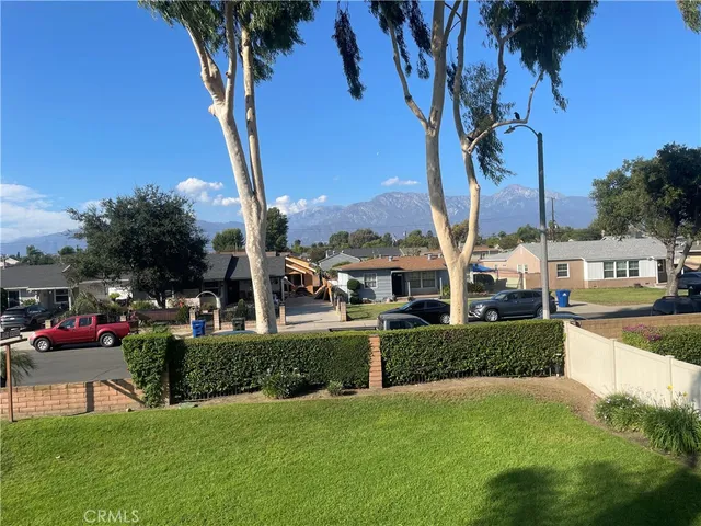 a view of street with tall buildings and a big yard