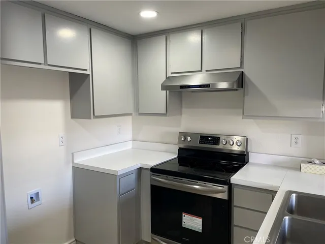 a kitchen with a stove and a refrigerator