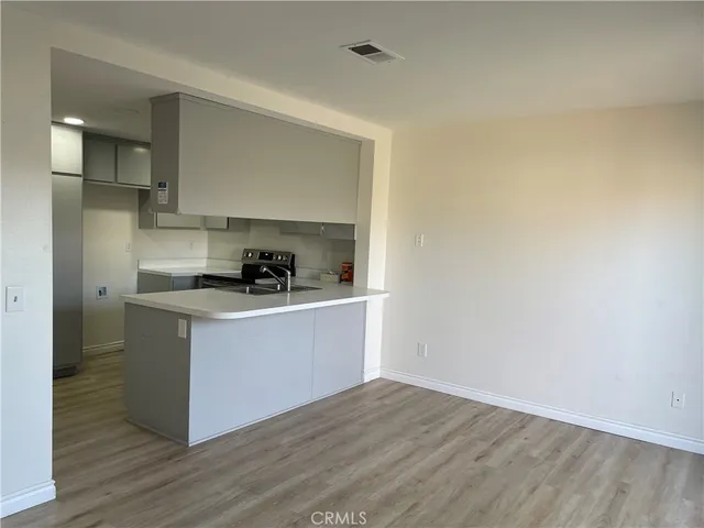 a kitchen with granite countertop a sink and cabinets