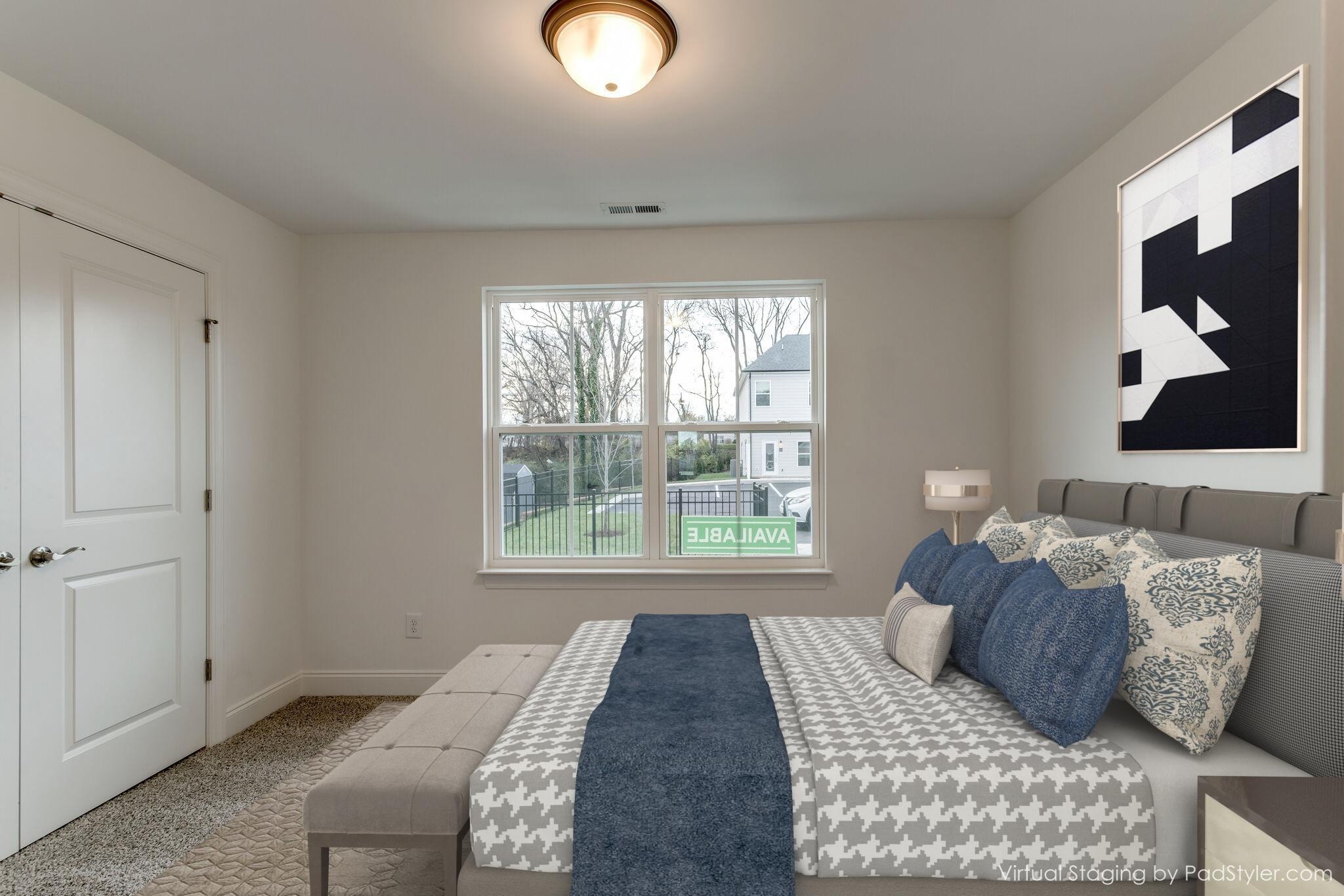 923 Southeast Broad Street, Unit B2 Murfreesboro, TN 37130 - Photo 11 of 32 a bed sitting in a bedroom next to a window