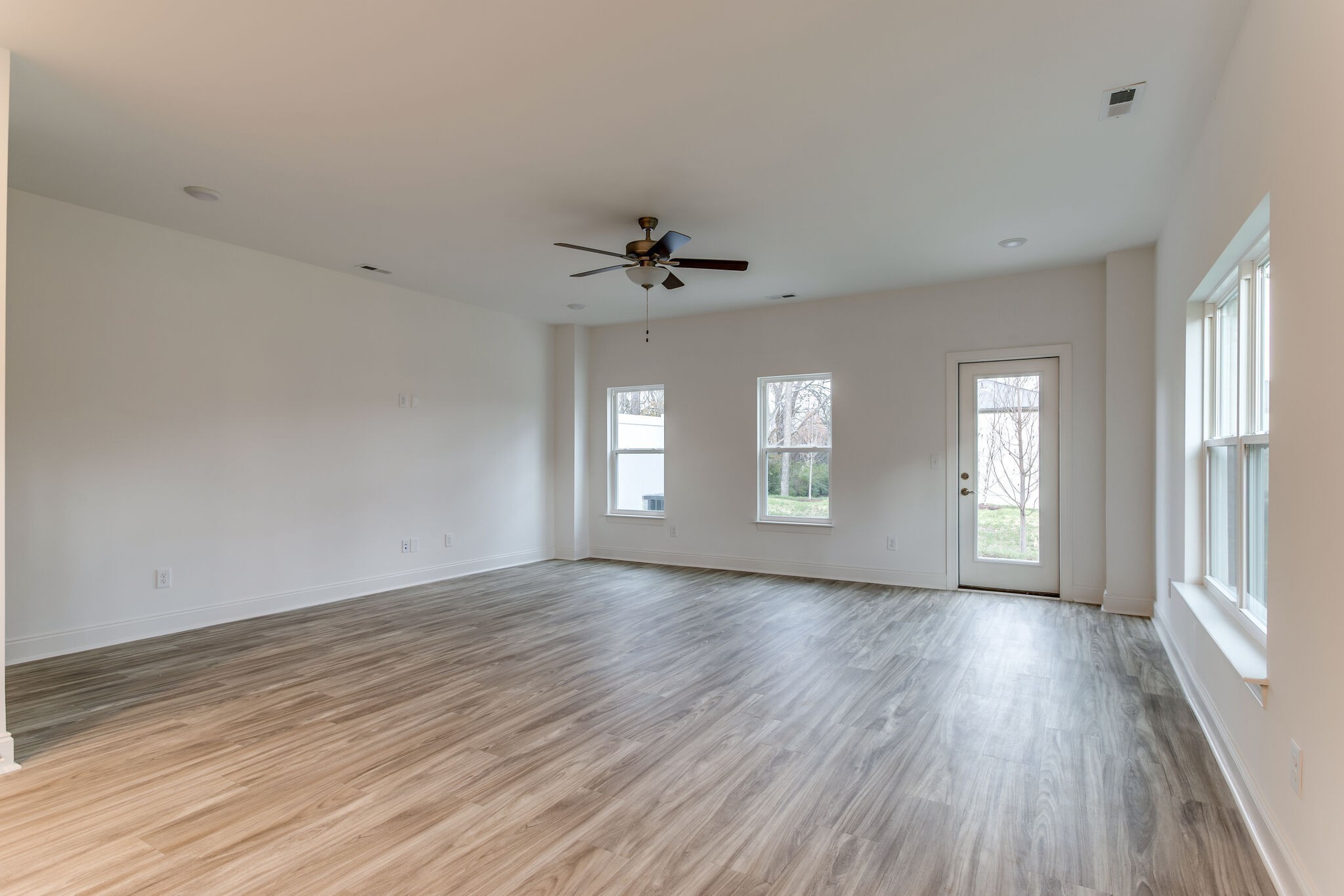 923 Southeast Broad Street, Unit B2 Murfreesboro, TN 37130 - Photo 19 of 32 a view of an empty room with a window and wooden floor