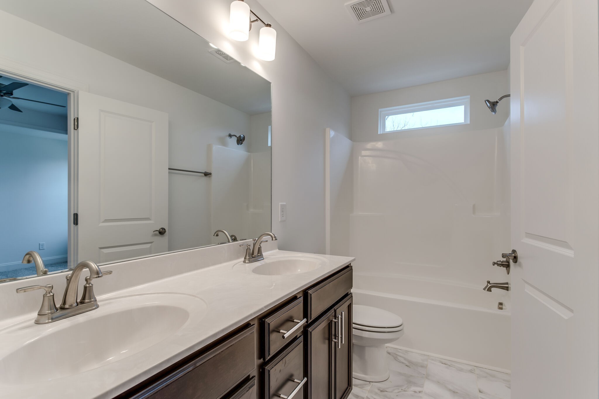 923 Southeast Broad Street, Unit B2 Murfreesboro, TN 37130 - Photo 27 of 32 a bathroom with a granite countertop sink toilet and shower