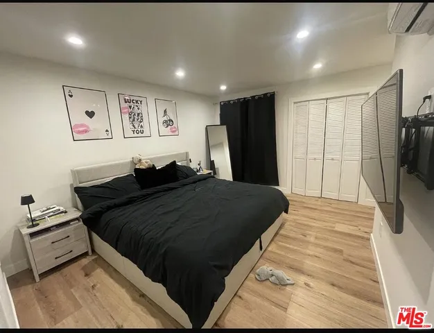 a bed room with a bed and a flat screen tv