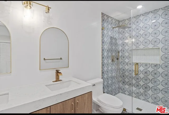 a bathroom with a sink a toilet and shower curtain