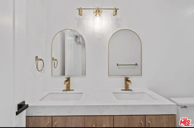 a bathroom with a double vanity sink