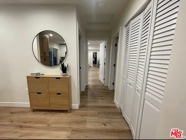 a view of a mirror on the wall and a wooden floor