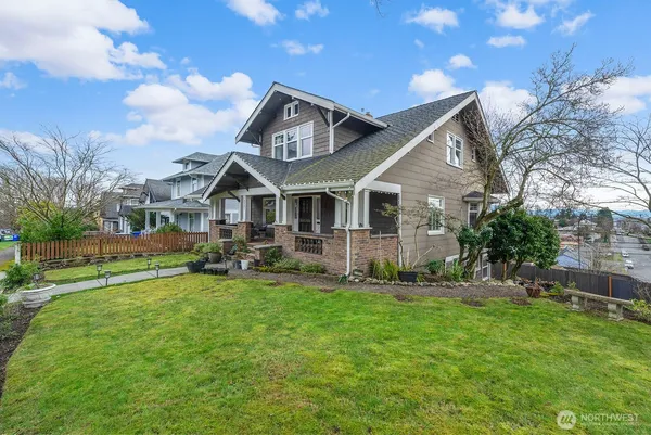 a front view of a house with yard and green space