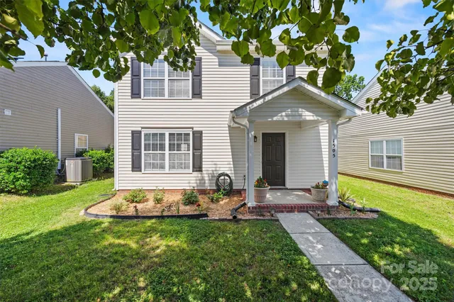 a front view of house with yard and outdoor seating
