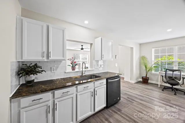 a kitchen with sink and cabinets