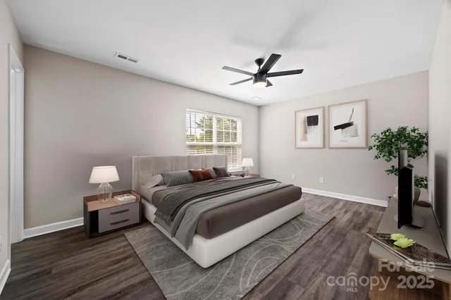 a bedroom with a large bed and a chandelier