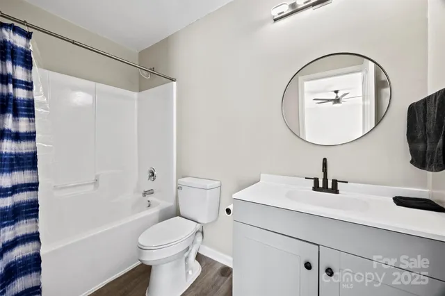 a bathroom with a sink toilet and a mirror