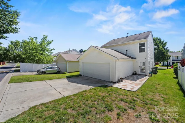 a view of a house with backyard and sitting area