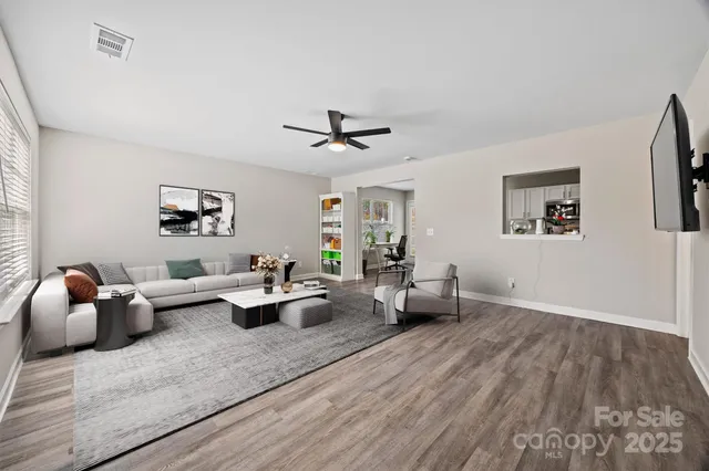 a living room with furniture and wooden floor