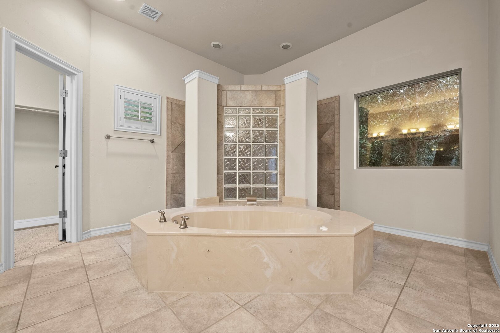 14041 Iron Horse Way Helotes, TX 78023 - Photo 19 of 49 a bathroom with bathtub and window