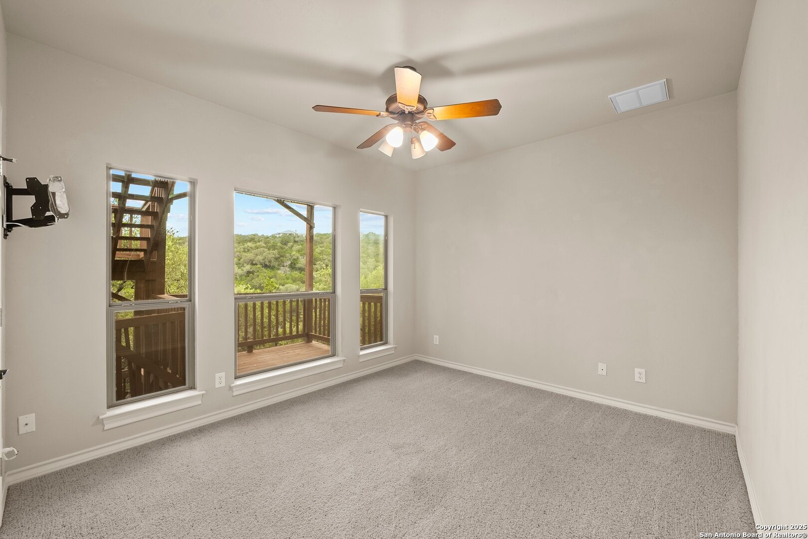 14041 Iron Horse Way Helotes, TX 78023 - Photo 25 of 49 an empty room with windows and fan