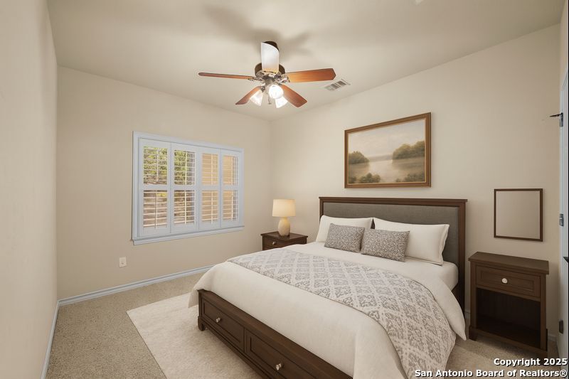 14041 Iron Horse Way Helotes, TX 78023 - Photo 27 of 49 a bedroom with a bed and a chandelier