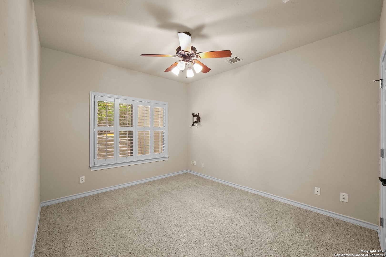 14041 Iron Horse Way Helotes, TX 78023 - Photo 28 of 49 an empty room with windows and fan