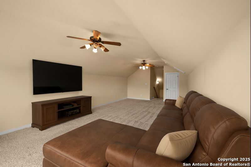 14041 Iron Horse Way Helotes, TX 78023 - Photo 31 of 49 a living room with furniture and a flat screen tv