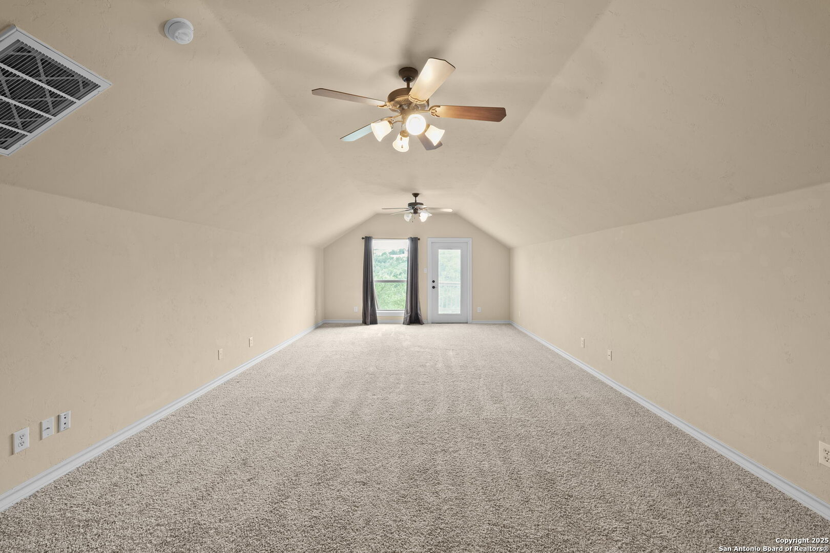 14041 Iron Horse Way Helotes, TX 78023 - Photo 33 of 49 a view of a room with a chandelier fan and windows