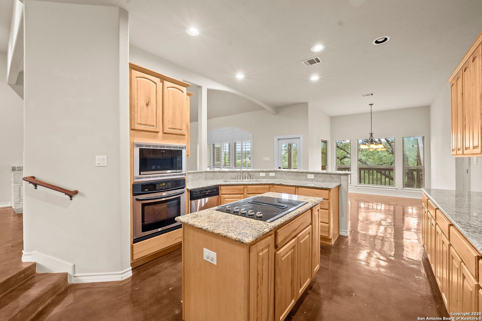 14041 Iron Horse Way Helotes, TX 78023 - Photo 10 of 49 a kitchen with stainless steel appliances granite countertop a stove and a refrigerator