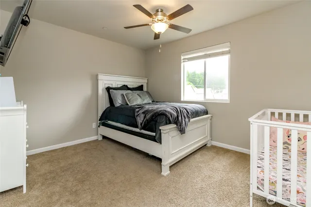 a bed sitting in a bedroom next to a window