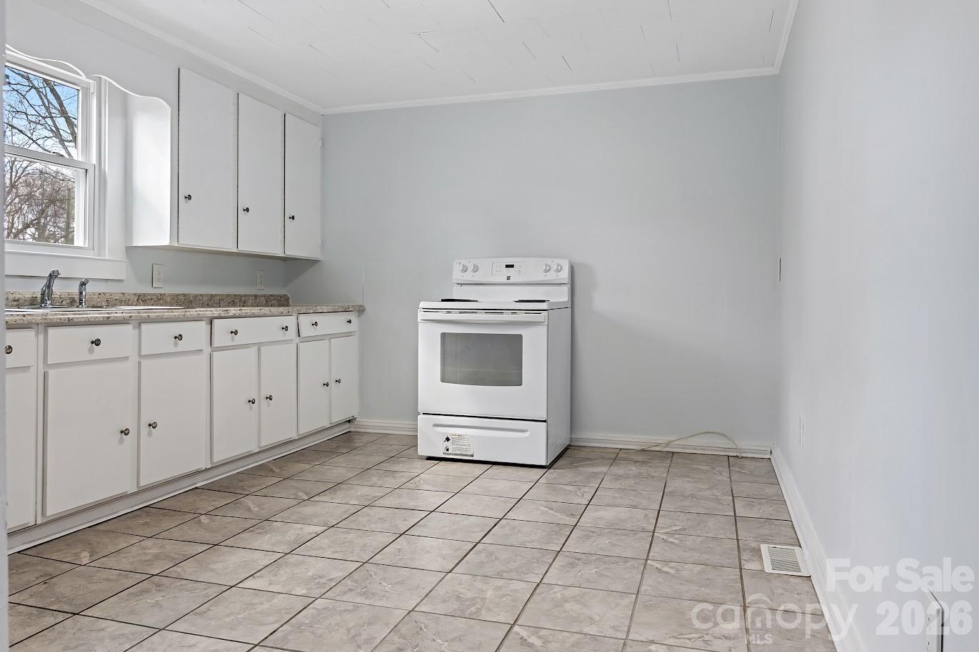 511 Stafford Street Monroe, NC 28110 - Photo 15 of 17 a utility room with cabinets washer and dryer