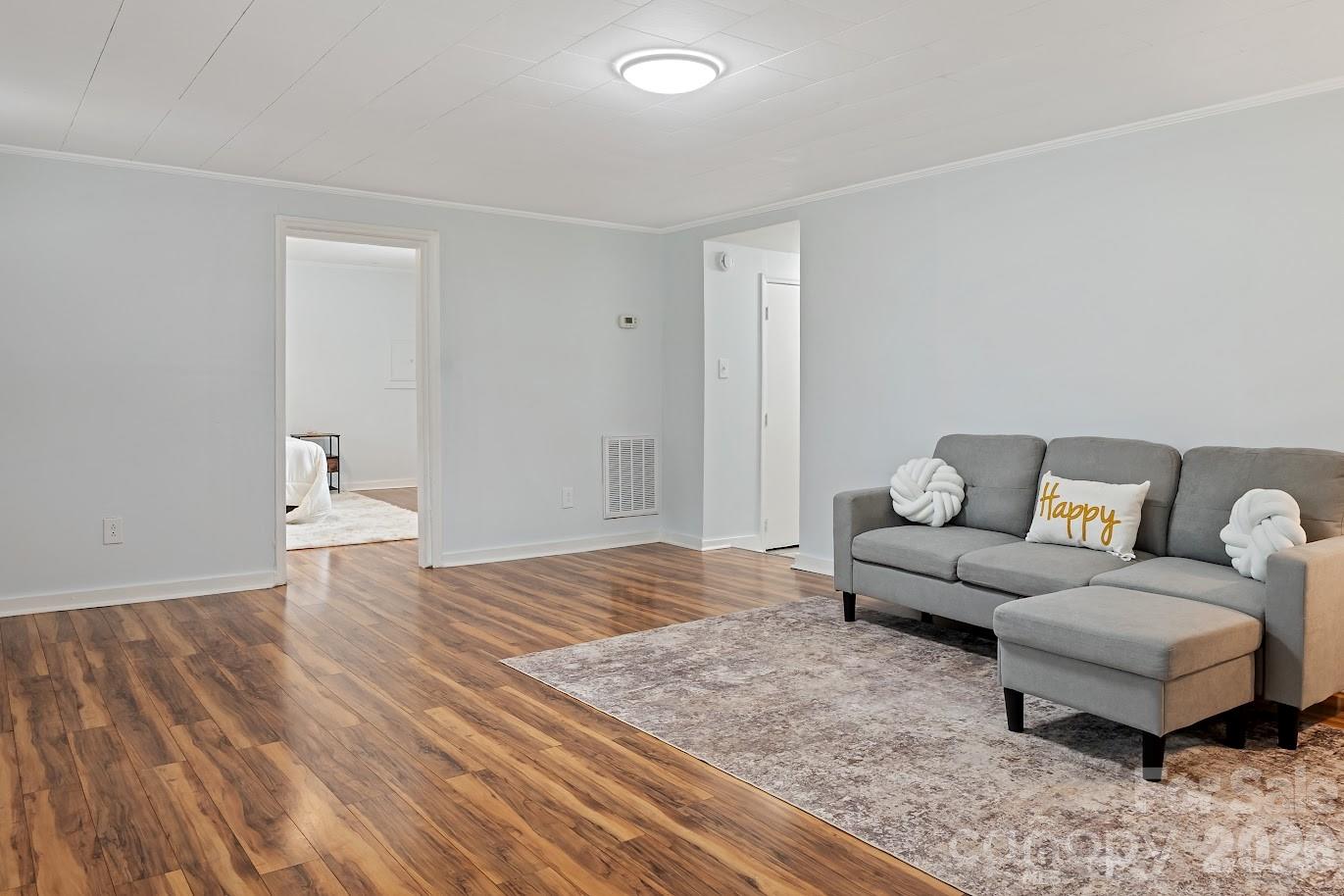 511 Stafford Street Monroe, NC 28110 - Photo 3 of 17 a living room with furniture and a wooden floor