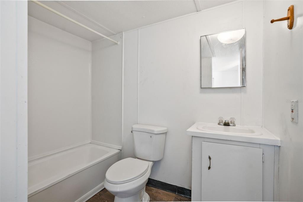 9342 Labelle Street New Port Richey, FL 34654 - Photo 13 of 20 a bathroom with a sink toilet and a mirror