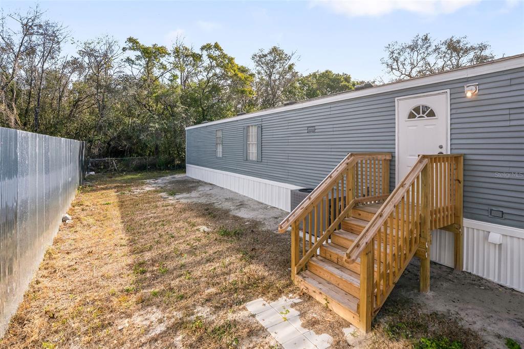 9342 Labelle Street New Port Richey, FL 34654 - Photo 16 of 20 a view of outdoor space with deck and backyard