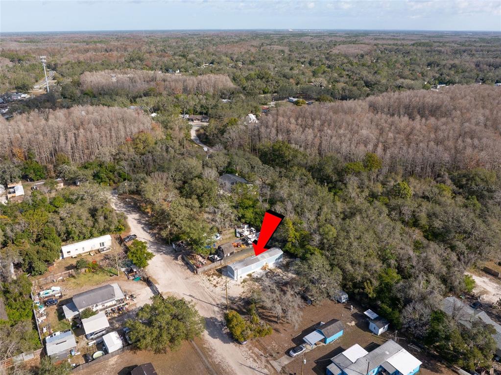 9342 Labelle Street New Port Richey, FL 34654 - Photo 19 of 20 an aerial view of a houses with a lush green hillside