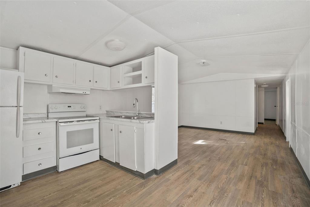 9342 Labelle Street New Port Richey, FL 34654 - Photo 4 of 20 a kitchen with cabinets wooden floor and a sink