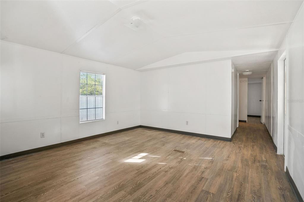 9342 Labelle Street New Port Richey, FL 34654 - Photo 6 of 20 an empty room with wooden floor and windows