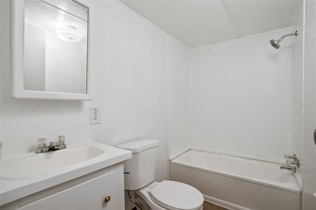 9342 Labelle Street New Port Richey, FL 34654 - Photo 10 of 20 a bathroom with a sink a toilet and shower