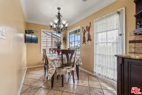 a view of a dining room with furniture and a chandelier